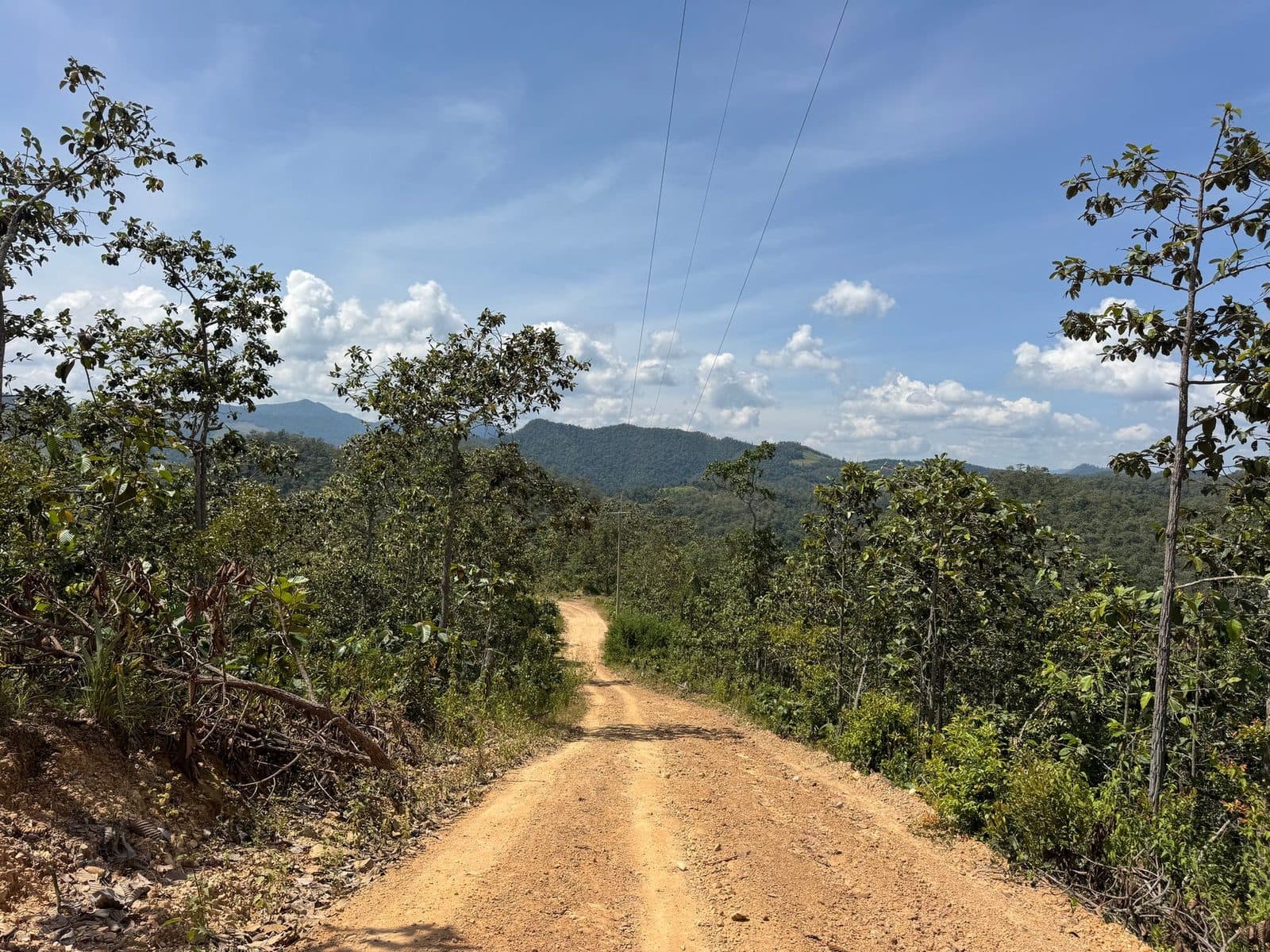 Red dirt and power lines. The track follows the poles for long stretches.