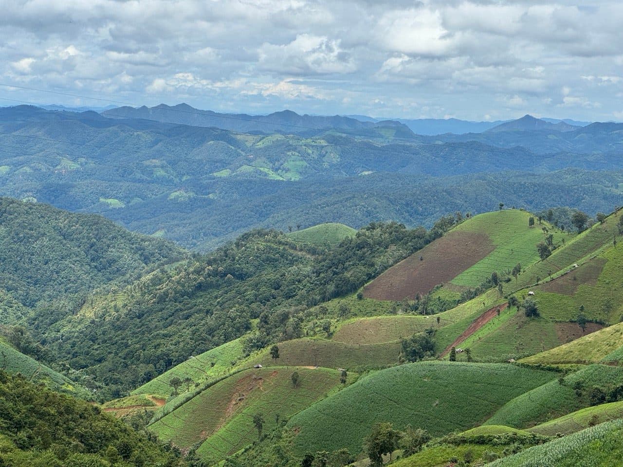 Ridge behind ridge, with hill farms cut into the near slopes.