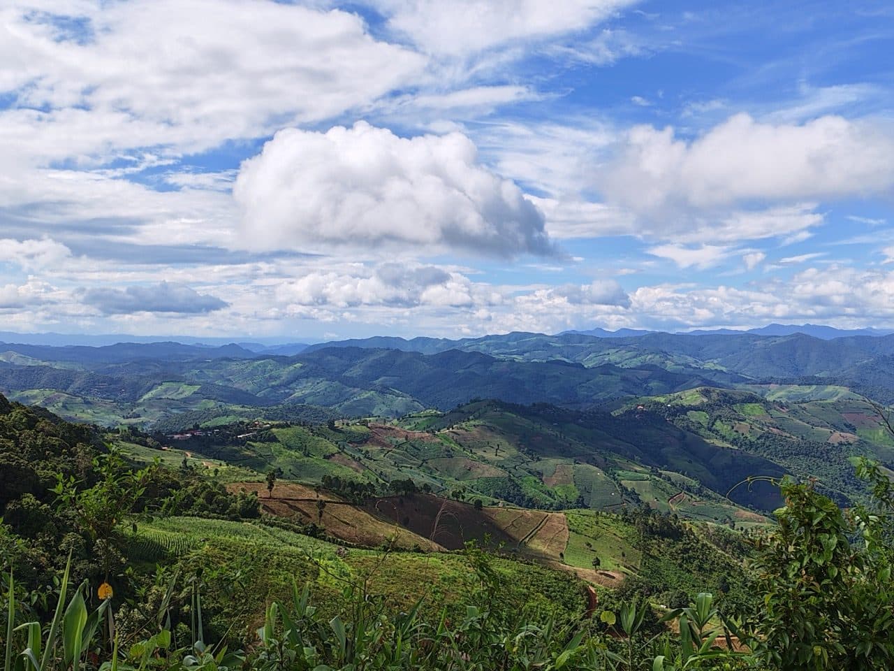 The Mae Chaem valley opening up under a big afternoon sky.