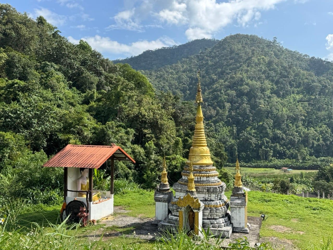 A Shan style chedi and shrine beside the road.