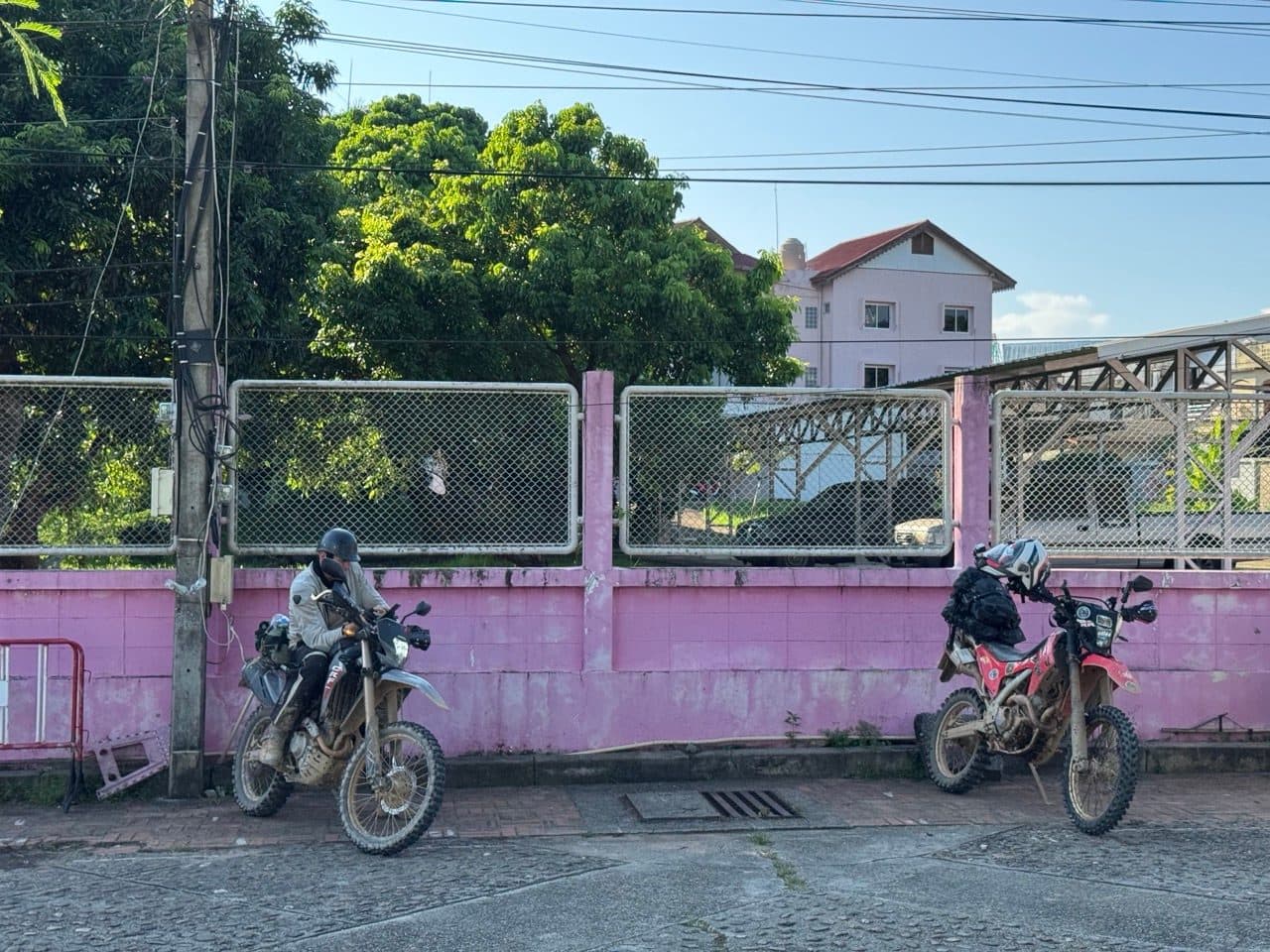 Both bikes against a pink wall in town.