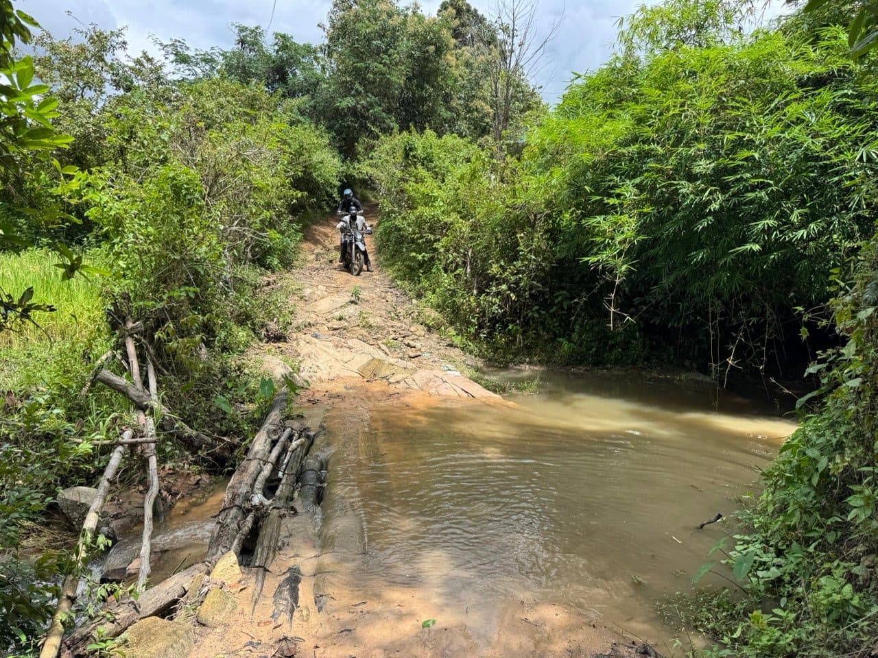 The ford over slab rock with a bamboo footbridge alongside